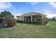 Large backyard with lush lawn and mature landscaping at 1985 White Feather Ln, Nokomis, FL 34275