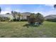 Spacious backyard with a grassy area and manicured hedges at 1985 White Feather Ln, Nokomis, FL 34275