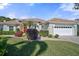 Single-story home with a tile roof, attached garage, and lush landscaping at 1985 White Feather Ln, Nokomis, FL 34275
