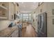 Spacious kitchen with granite countertops, stainless steel appliances, and an eat-in area at 1985 White Feather Ln, Nokomis, FL 34275