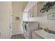 Convenient laundry room with washer, dryer, and utility sink at 1985 White Feather Ln, Nokomis, FL 34275