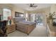 Spacious main bedroom with a wicker bed frame and access to a private patio at 1985 White Feather Ln, Nokomis, FL 34275