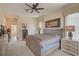 Main bedroom with a comfortable king-size bed and direct access to bathroom at 1985 White Feather Ln, Nokomis, FL 34275