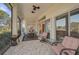 Spacious screened-in porch with patio furniture and ceiling fans at 1985 White Feather Ln, Nokomis, FL 34275