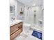 Updated bathroom with a walk-in shower and stylish wood vanity at 20 Whispering Sands Dr # 306, Sarasota, FL 34242