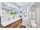 Modern bathroom with double vanity, large mirror, and stylish wood cabinets at 20 Whispering Sands Dr # 306, Sarasota, FL 34242