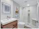 Modern bathroom with a walk-in shower, white subway tile, and wood vanity at 20 Whispering Sands Dr # 306, Sarasota, FL 34242