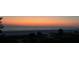 Stunning sunset view over a tranquil beach with people strolling along the shore at 20 Whispering Sands Dr # 306, Sarasota, FL 34242