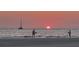 Two people enjoying the sunset on the beach at 20 Whispering Sands Dr # 306, Sarasota, FL 34242