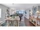 Bright dining area with ocean views and a rustic farmhouse table at 20 Whispering Sands Dr # 306, Sarasota, FL 34242