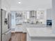 Modern white kitchen with stainless steel appliances at 20 Whispering Sands Dr # 306, Sarasota, FL 34242