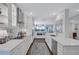 Modern white kitchen with stainless steel appliances and ocean view at 20 Whispering Sands Dr # 306, Sarasota, FL 34242