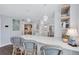 Modern white kitchen with island and breakfast bar at 20 Whispering Sands Dr # 306, Sarasota, FL 34242