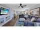 Spacious living room featuring a large sectional sofa, hardwood floors, and a view into the dining area at 20 Whispering Sands Dr # 306, Sarasota, FL 34242