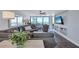 Living room with sectional sofa, built-in shelving, and ocean view at 20 Whispering Sands Dr # 306, Sarasota, FL 34242
