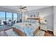 Main bedroom with king-size bed, ocean view, and private balcony access at 20 Whispering Sands Dr # 306, Sarasota, FL 34242