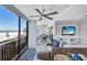Bright condo living area with captivating ocean views, comfortable seating, and a dining table at 20 Whispering Sands Dr # 306, Sarasota, FL 34242