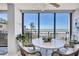Condo dining area with stunning ocean view and comfortable wicker seating at 20 Whispering Sands Dr # 306, Sarasota, FL 34242