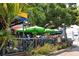 Restaurant patio with outdoor seating under umbrellas at 20 Whispering Sands Dr # 306, Sarasota, FL 34242