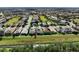 Aerial view of a residential community featuring numerous homes and lush landscaping at 204 Venice Palms Blvd, Venice, FL 34292