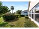 Landscaped backyard with lush greenery and mature trees at 204 Venice Palms Blvd, Venice, FL 34292
