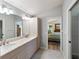 Main bathroom with double sinks and access to bedroom at 204 Venice Palms Blvd, Venice, FL 34292