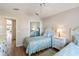 Bedroom with twin beds and built-in wooden wardrobe at 204 Venice Palms Blvd, Venice, FL 34292