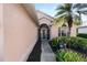 Front entrance with a walkway and landscaping at 204 Venice Palms Blvd, Venice, FL 34292