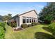 Well-maintained house with sunroom addition, landscaping, and spacious backyard at 204 Venice Palms Blvd, Venice, FL 34292