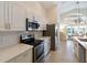 Bright kitchen, stainless steel appliances, and light-colored cabinets at 204 Venice Palms Blvd, Venice, FL 34292