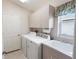Laundry room with washer, dryer, and storage cabinets at 204 Venice Palms Blvd, Venice, FL 34292
