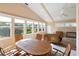 Bright sunroom with wicker furniture and view of the golf course at 204 Venice Palms Blvd, Venice, FL 34292