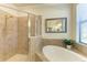 Bathroom with walk-in shower and a separate soaking tub at 20710 Saluti Pl, Venice, FL 34293