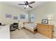 Cozy bedroom featuring a twin bed, dresser, and workspace at 20710 Saluti Pl, Venice, FL 34293