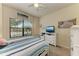 Guest bedroom with full-size bed and large window at 20710 Saluti Pl, Venice, FL 34293