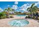 Relaxing hot tub nestled amongst palm trees and comfortable seating at 20710 Saluti Pl, Venice, FL 34293
