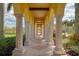 Covered walkway with arches and columns, providing shade and elegance at 20710 Saluti Pl, Venice, FL 34293