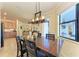 Bright dining area with a wooden table and chairs, view into the living room at 20710 Saluti Pl, Venice, FL 34293