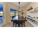 Rustic dining room with wooden table and water views at 20710 Saluti Pl, Venice, FL 34293