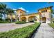 Gated entrance to Gran Paradiso community with lush landscaping and Mediterranean architecture at 20710 Saluti Pl, Venice, FL 34293