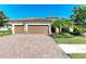 Beautiful three-car garage home with paver driveway and landscaping at 20710 Saluti Pl, Venice, FL 34293