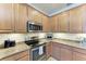 Bright kitchen with wood cabinets and granite countertops at 20710 Saluti Pl, Venice, FL 34293