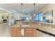 L-shaped kitchen with island and stainless steel appliances at 20710 Saluti Pl, Venice, FL 34293