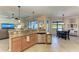 Open kitchen with island, granite counters & breakfast bar at 20710 Saluti Pl, Venice, FL 34293