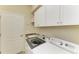 Laundry room with washer, dryer, and upper cabinets at 20710 Saluti Pl, Venice, FL 34293
