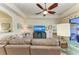 Open living room with large TV and access to the pool and lanai at 20710 Saluti Pl, Venice, FL 34293