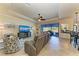 Relaxing living room with large TV, comfortable seating, and access to the lanai at 20710 Saluti Pl, Venice, FL 34293