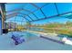 Inviting pool and spa with screened enclosure and lake view at 20710 Saluti Pl, Venice, FL 34293