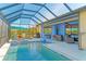 Relaxing pool and patio area with covered seating and outdoor kitchen at 20710 Saluti Pl, Venice, FL 34293