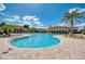 Large freeform community pool surrounded by lush landscaping at 20710 Saluti Pl, Venice, FL 34293